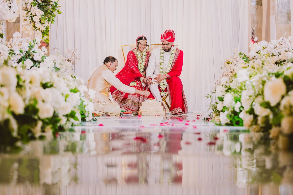 An indian bride and groom doing a ritual during their hindu ceremony at the hanover marriott