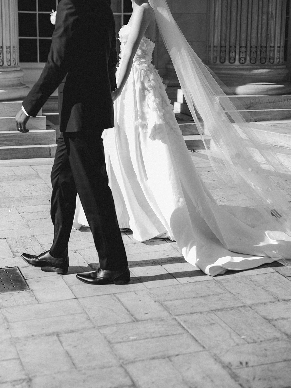 Photo of moment of couple walking  on their wedding day