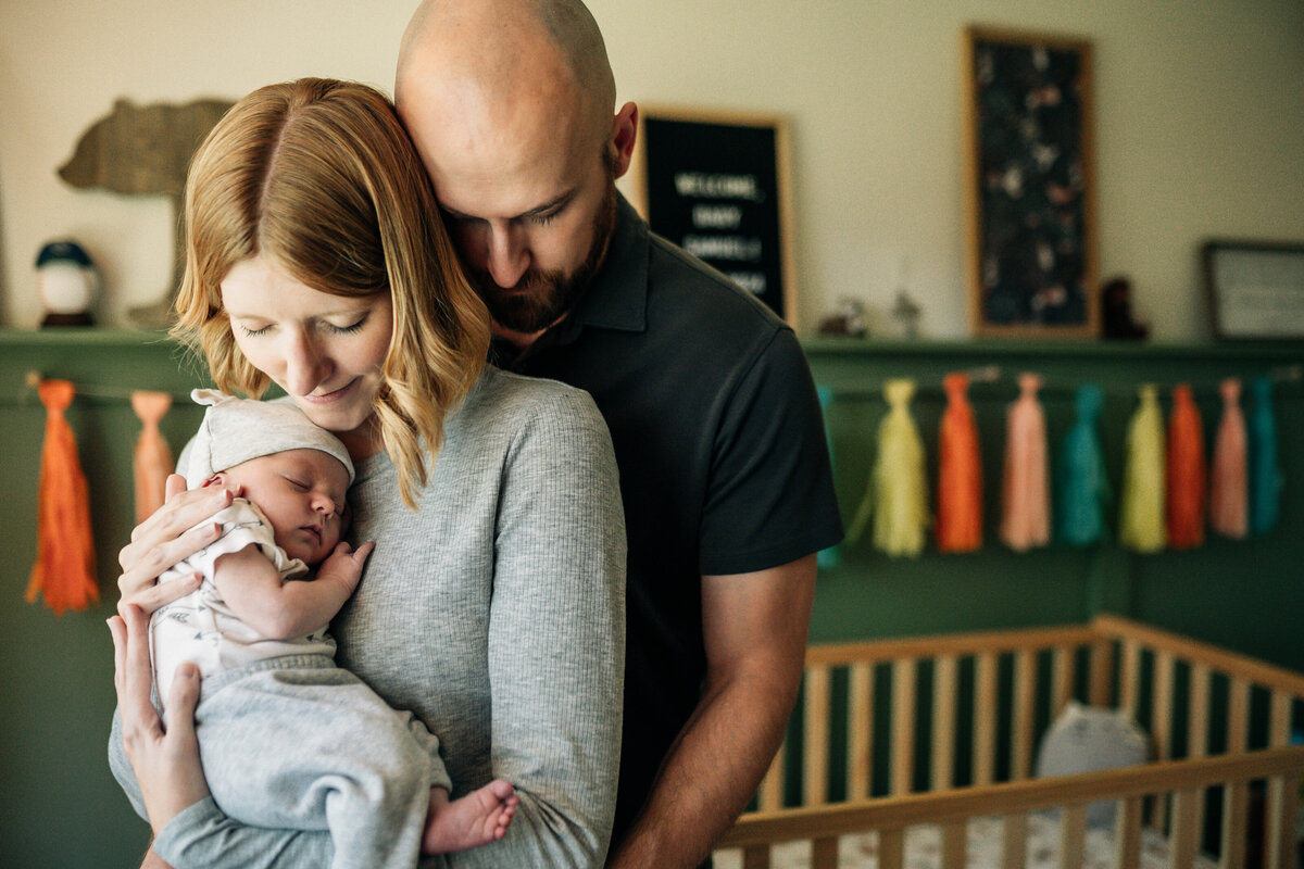 Mother holding newborn in light-filled Akron nursery