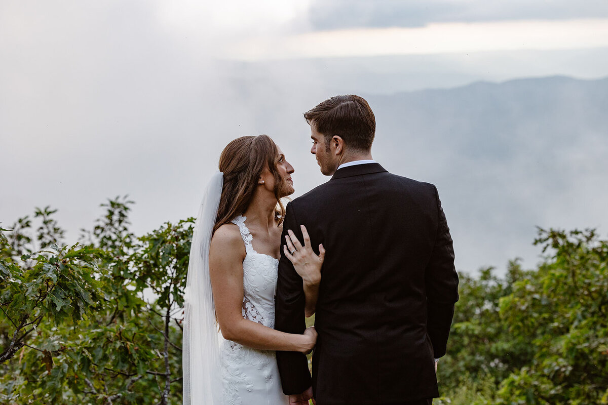A person facing the opposite direction of their partner with their arms linked