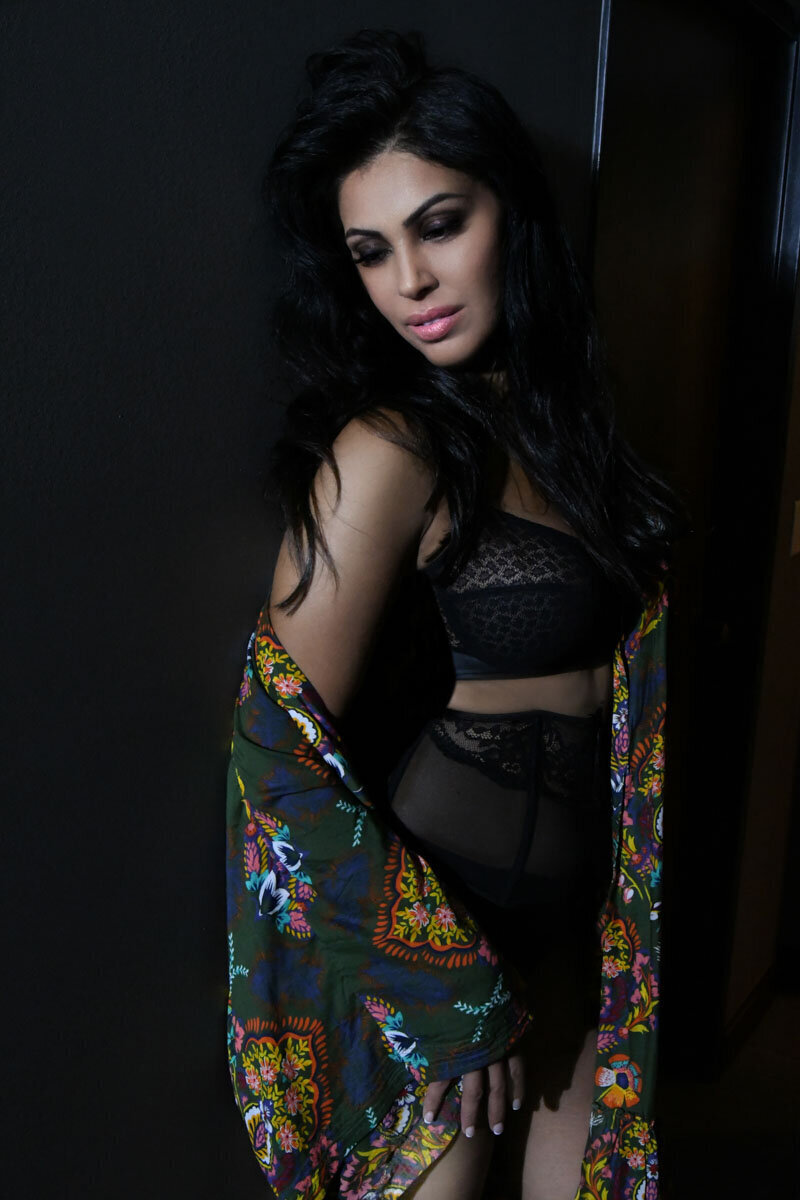 a woman posing in a black outfit