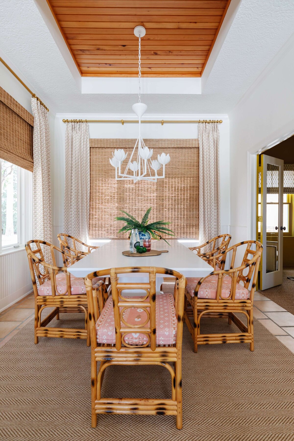 oyster creek studios home on the range brown wooden chairs with pink cushions with natural shades in dining room