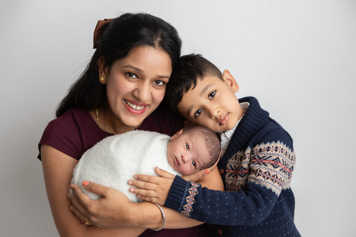 Mom with her two boys newborn photography pose