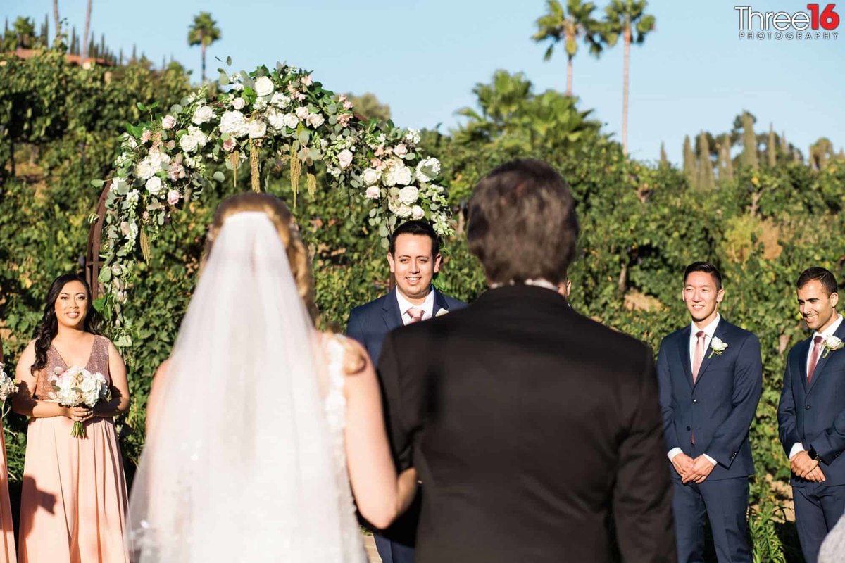 Groom waits at the altar as Bride's father walks up the aisle