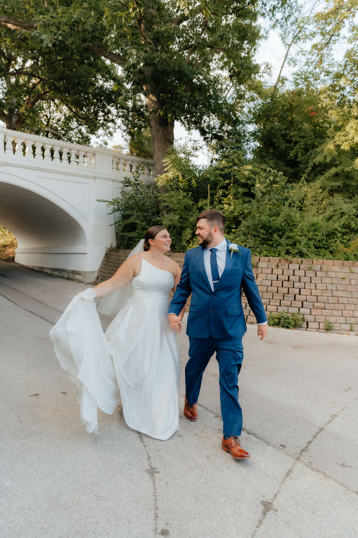 Couple walking hand-in-hand after ceremony, natural and joyful wedding portraits for easygoing Michigan couples who value connection and ease