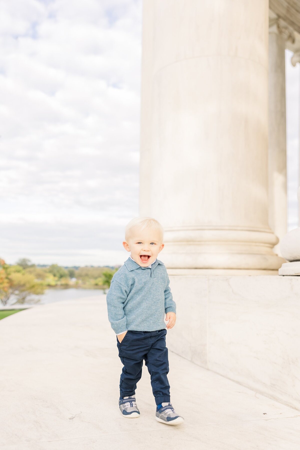 Toddler boy walking with a hand in his pocket by an Ohio family photographer