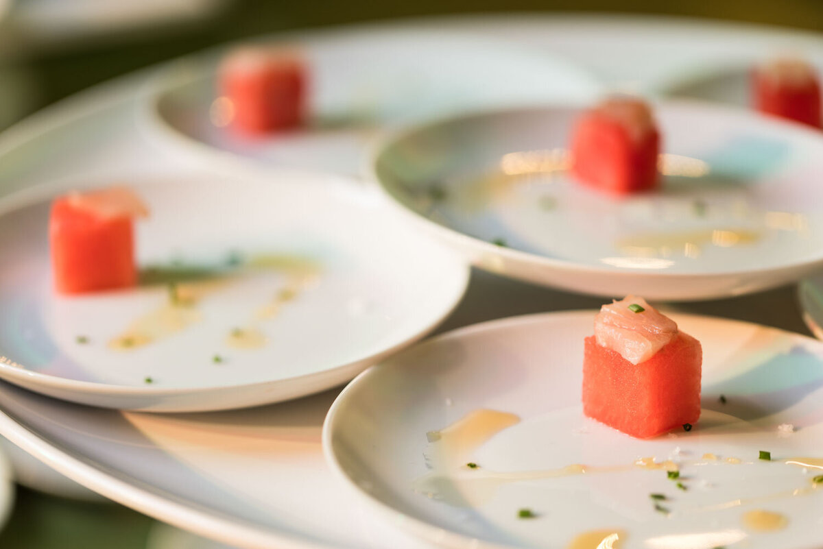 Watermelon and tuna cubes on white plates
