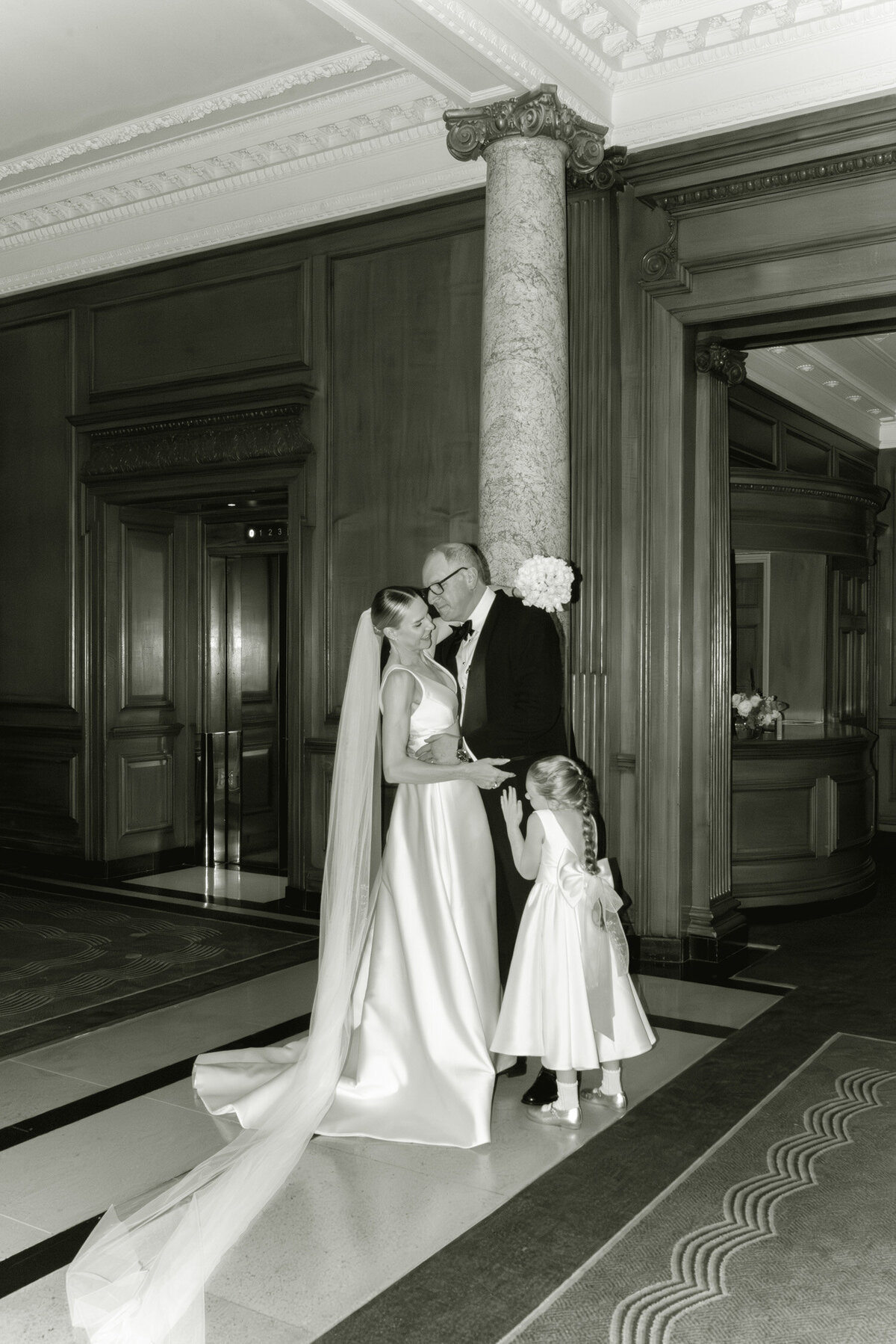 Editorial wedding photography of Bride and Groom and daughter on their Gleneagles wedding day.  Image by Scotland wedding photographer, Jill Cherry Porter.