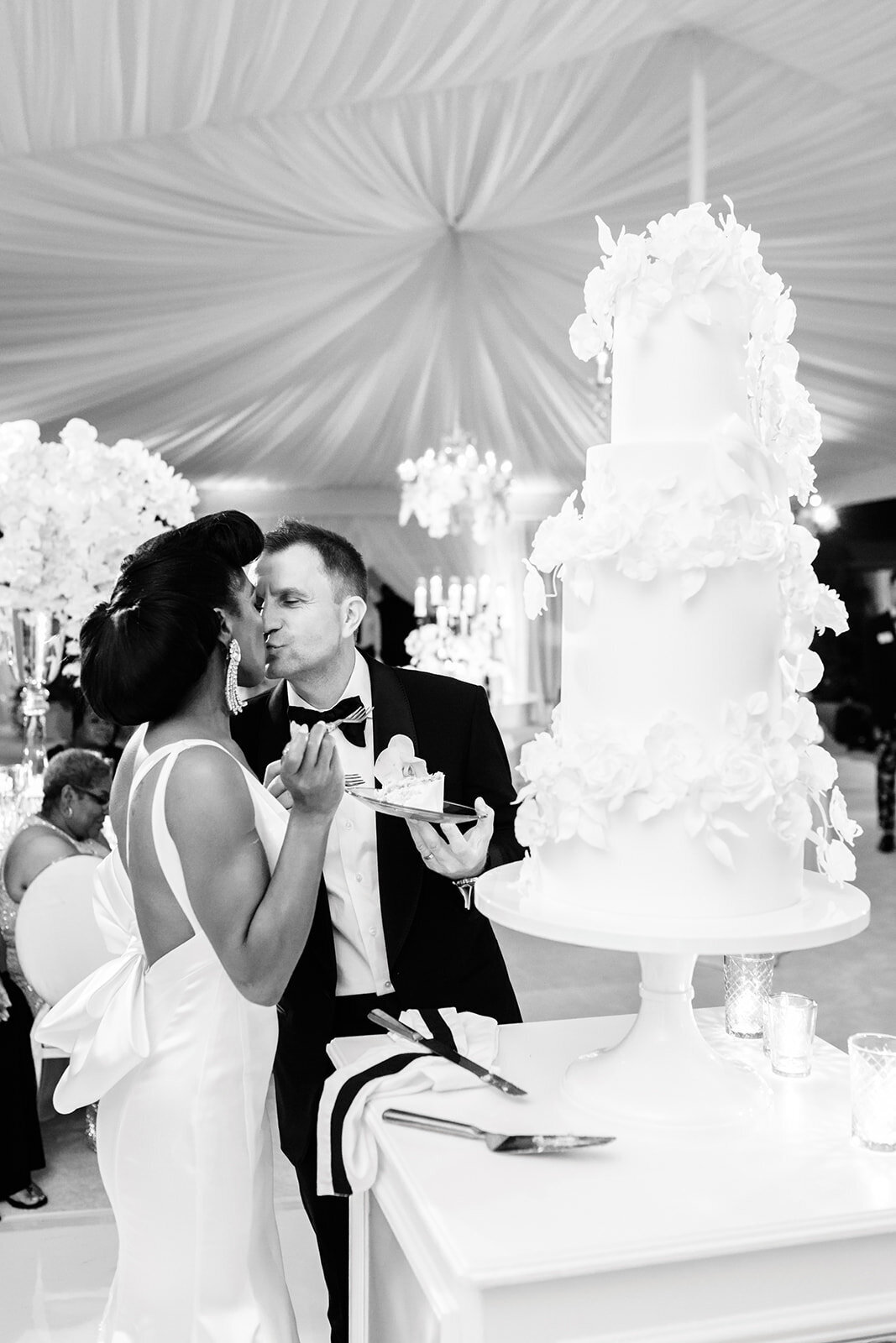 Bride and groom share a dance in black and white, capturing a timeless moment.