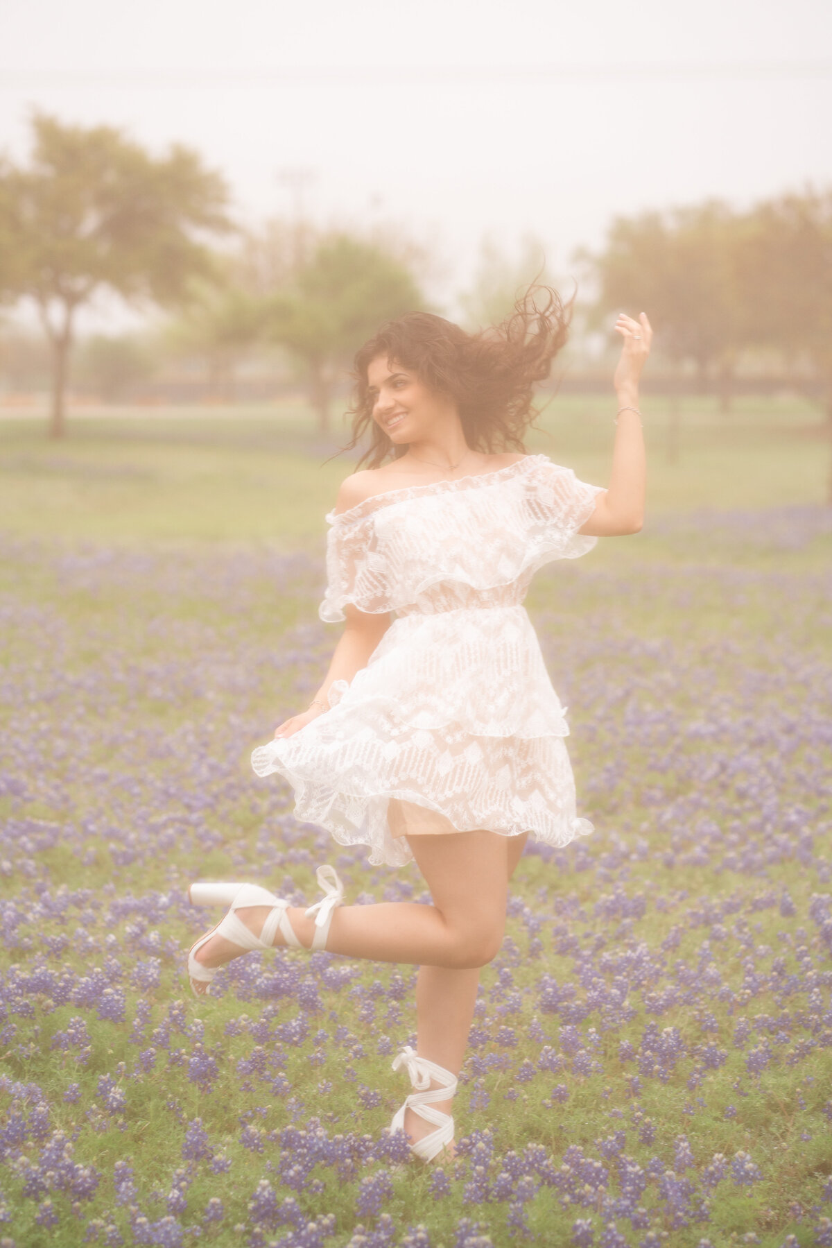 High school senior girl wearing a white dress in Austin Texas.
