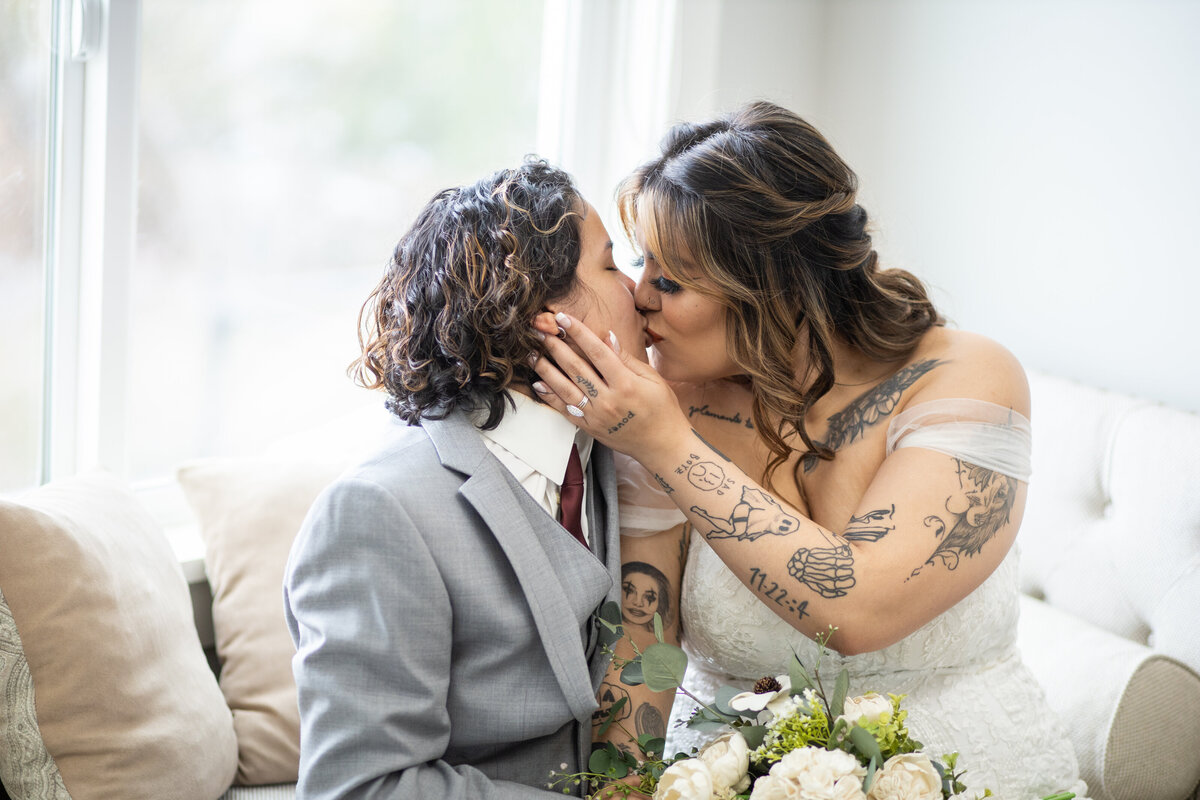 Lesbian couple kissing wedding photos