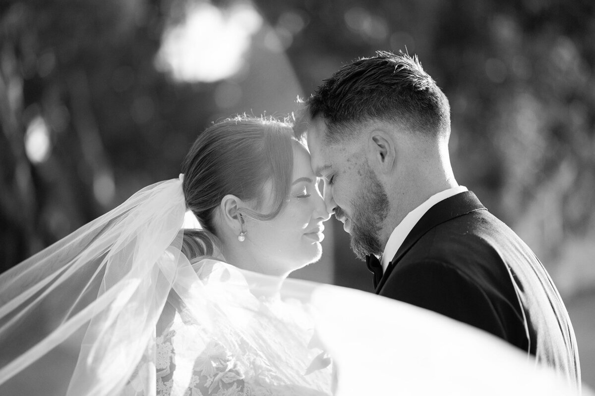 Bride and groom sharing an intimate moment at sunset