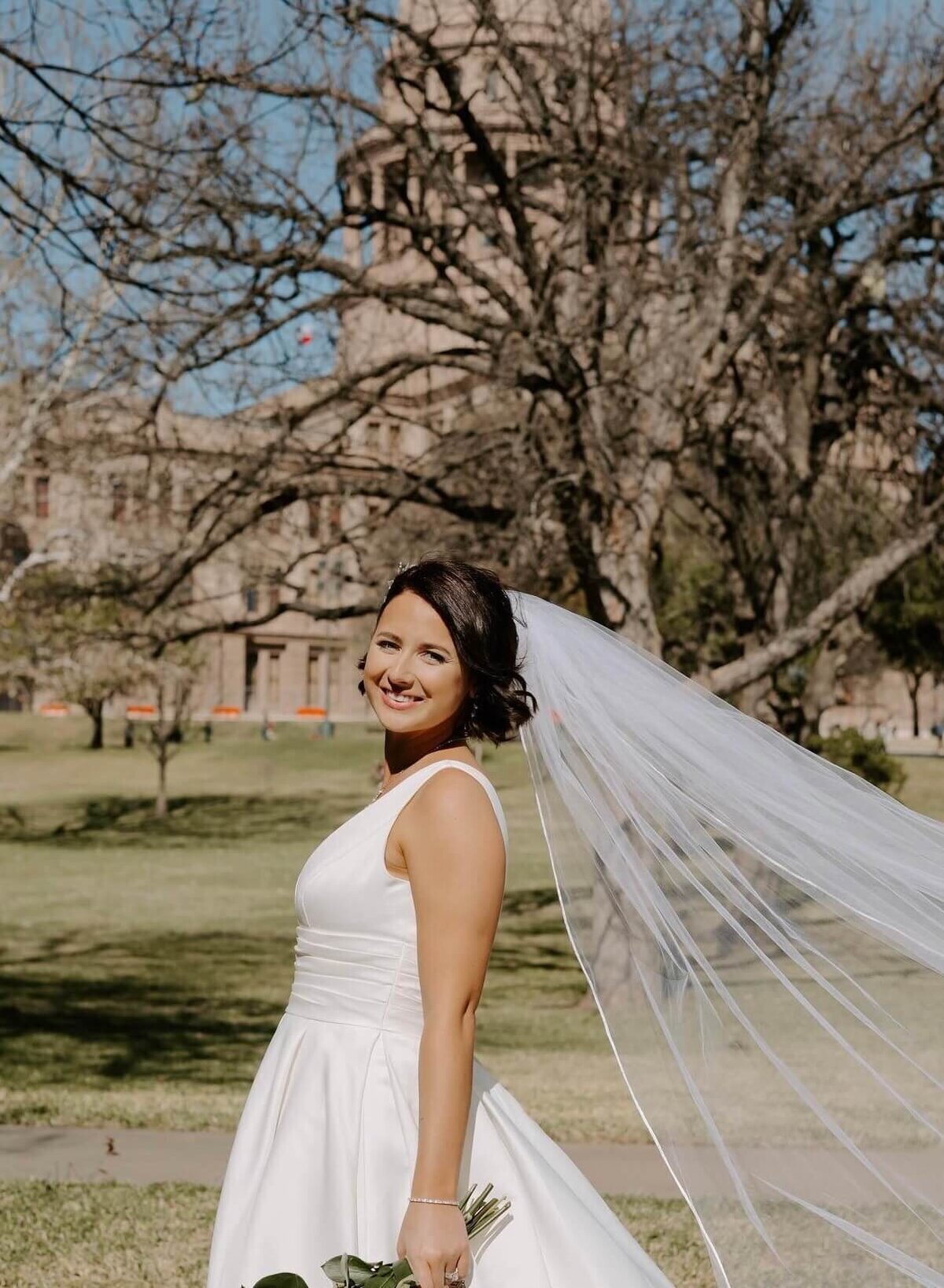 This radiant bride showcases flawless wedding hair and makeup in Austin, captured against the iconic Texas Capitol backdrop. Our Austin stylists specialize in bridal hair & makeup services, ensuring every bride feels confident and camera-ready. Perfect for elegant elopements or full wedding parties, Mistique Makeup delivers professional on-site beauty tailored to your vision.