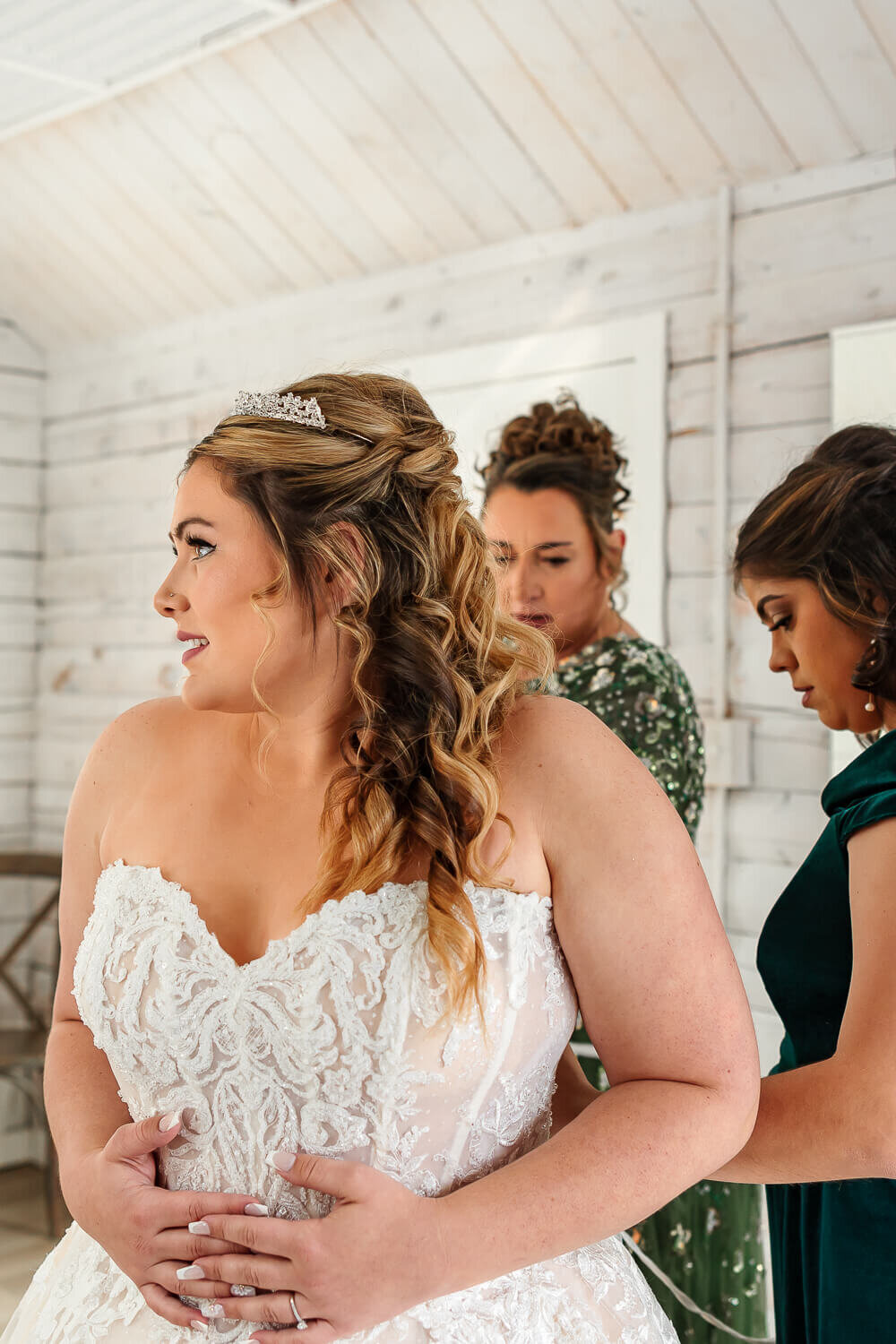 brides mom and maid of honor putting on dress. Colorado Springs, CO.