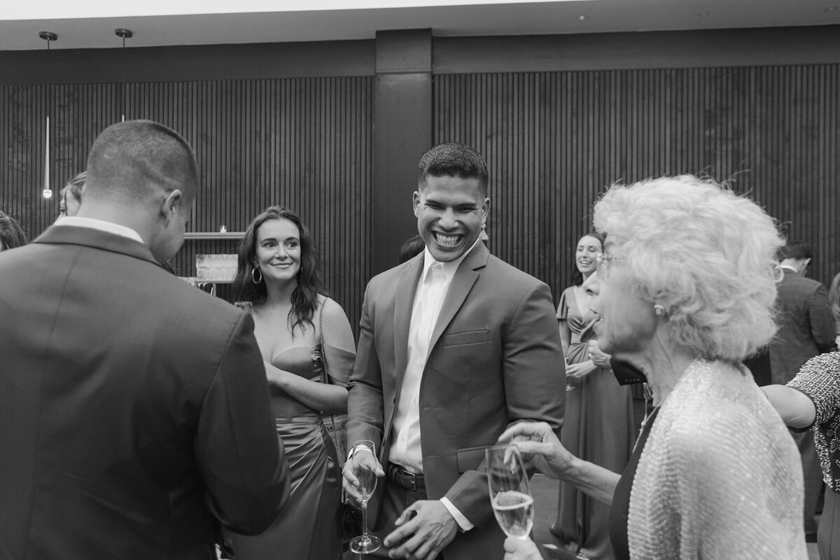 guy laughing at wedding reception