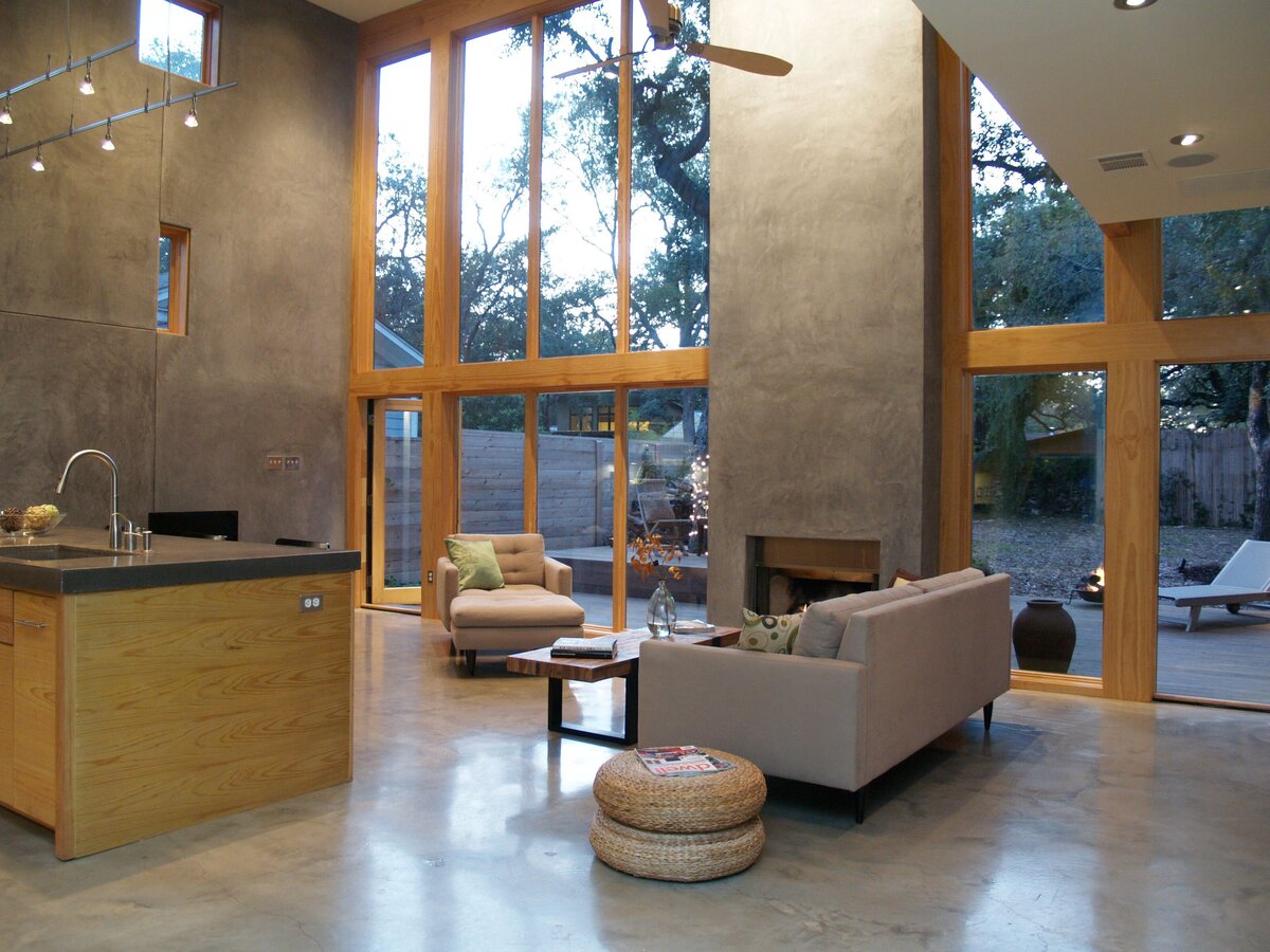 concrete living room with wooden accent wall. custom fireplace.