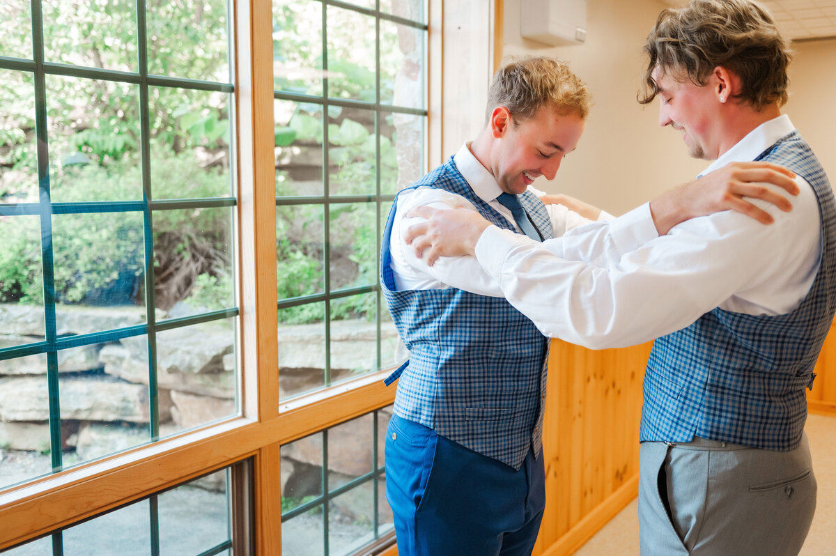 groom and his brother getting ready for wedding in kramer hall