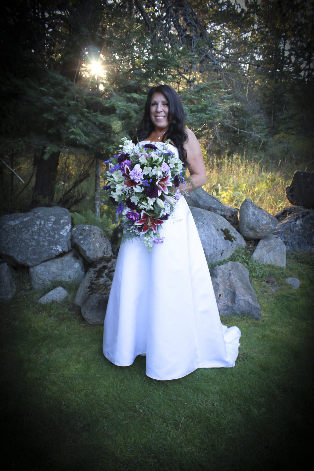 Bayview Idaho  Bride in forest setting with sun beaming through trees