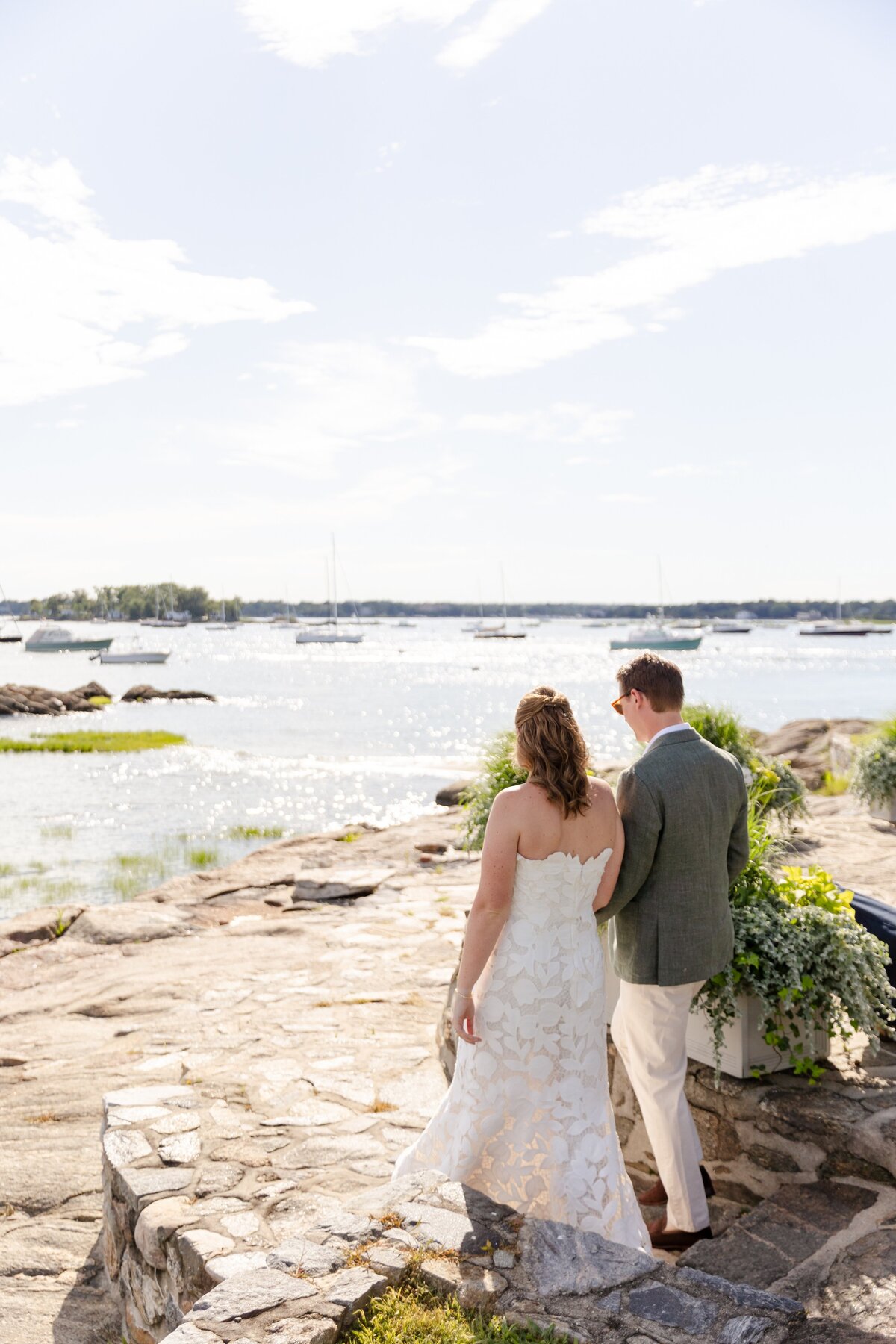 couple holding hand walking to the water during golden hour at American Yacht Club in Rye, NY