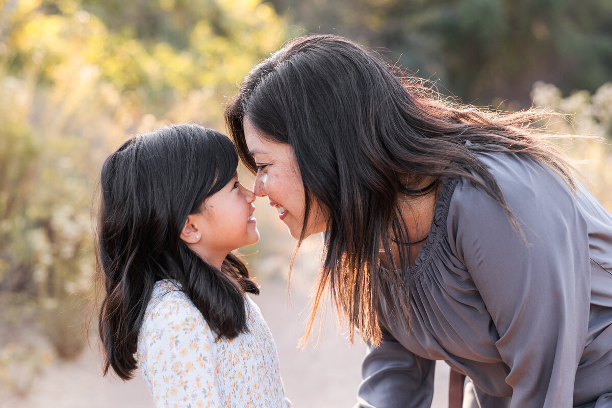 mother and daughter touching noses