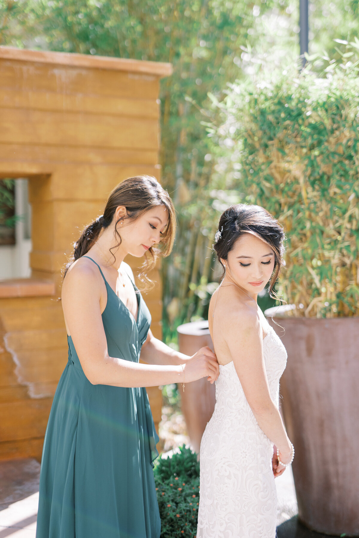 bridesmaid zipping up dress