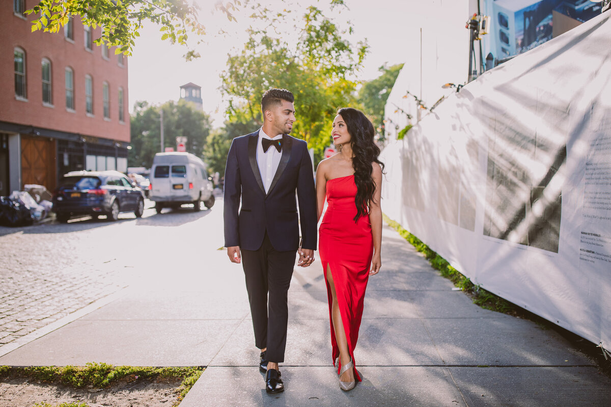 A couple walking down the street at brooklyn bridge park in formal reception clothing