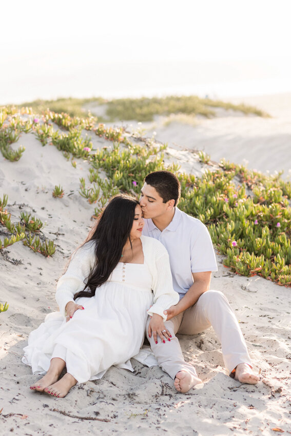 couple-sitting-in-sand-dunes-Coronado-San-Diego