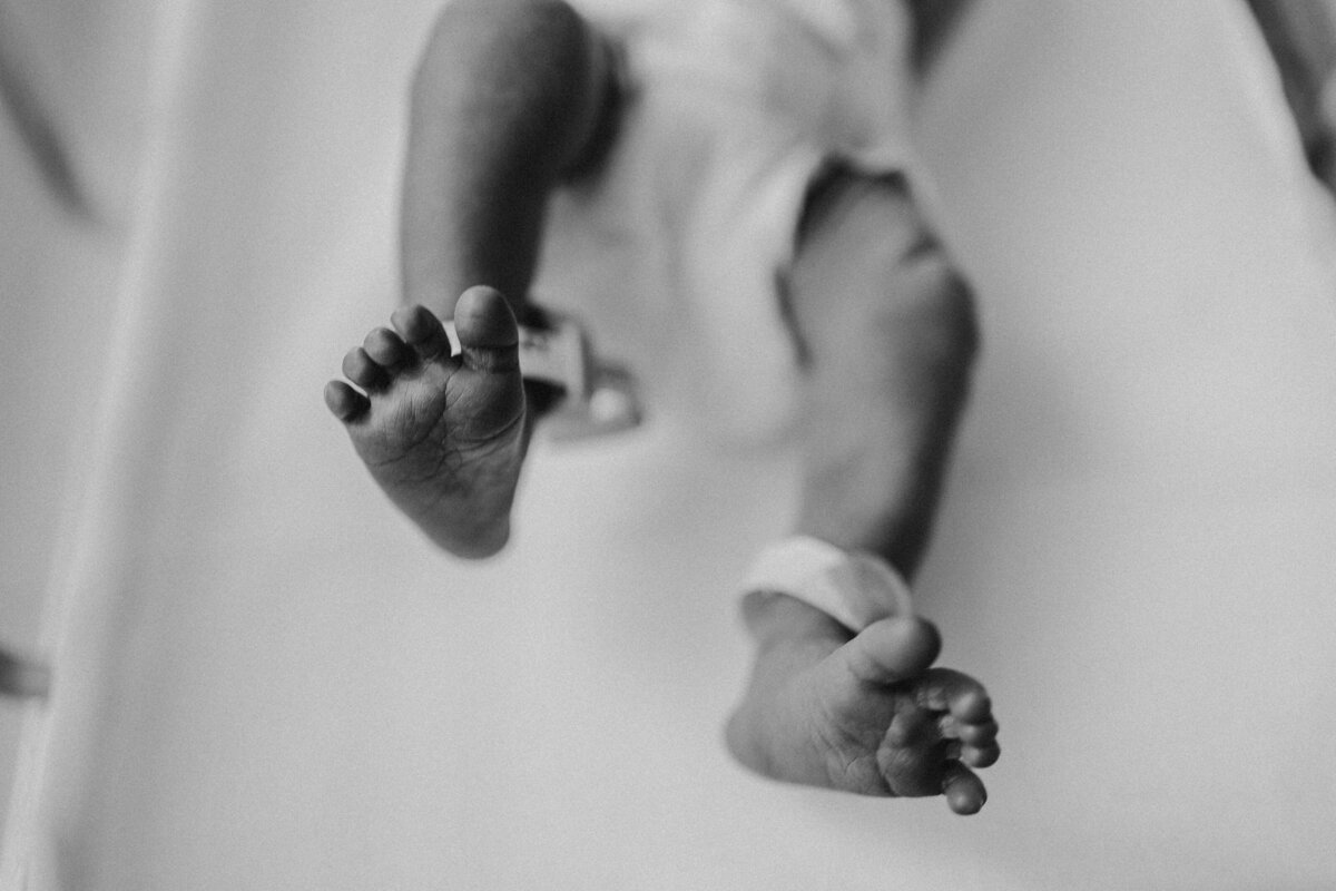 Pictures of a newborn's feet in diapers