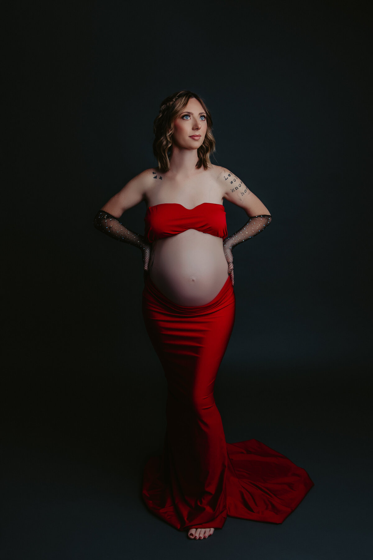 pregnant mother wearing a two piece dress that emphasizes her belly bump