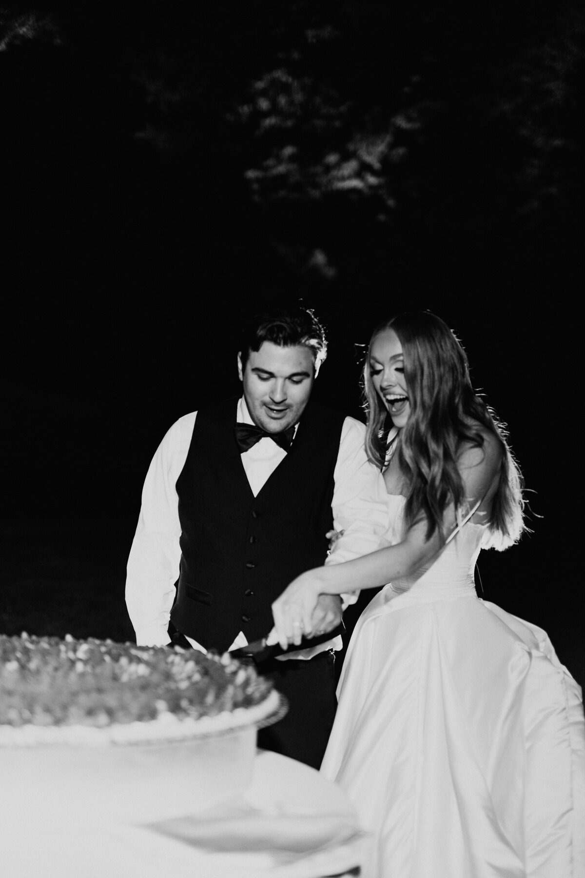 Bride and groom cutting Italian wedding cake in italy