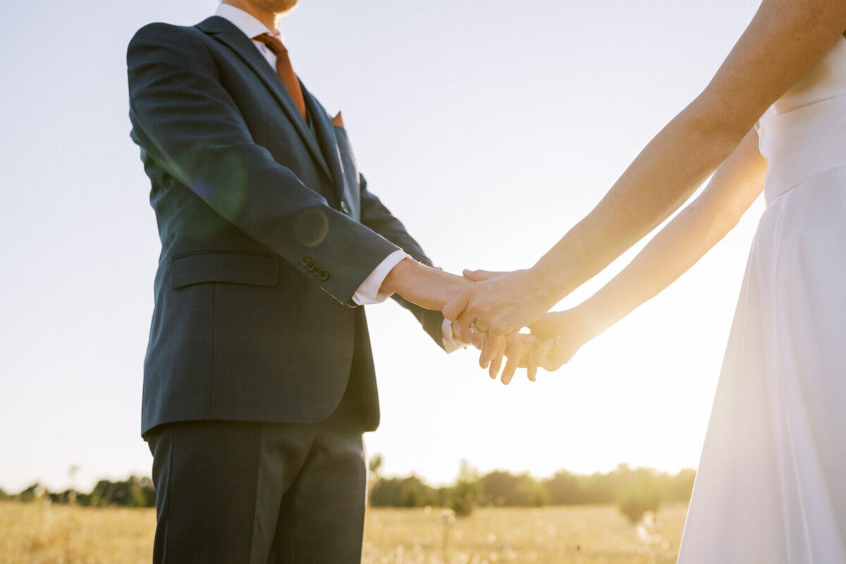 holding-hands-with-sun-flare