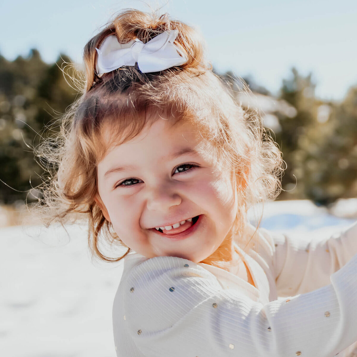 denver family photography - little girl smiling with ribbon in hair