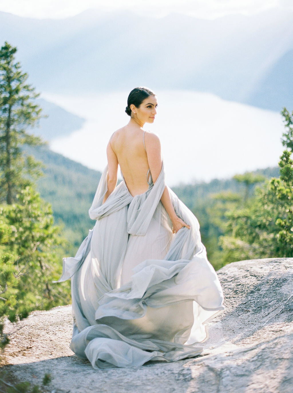 model in grey flowly dress on mountain