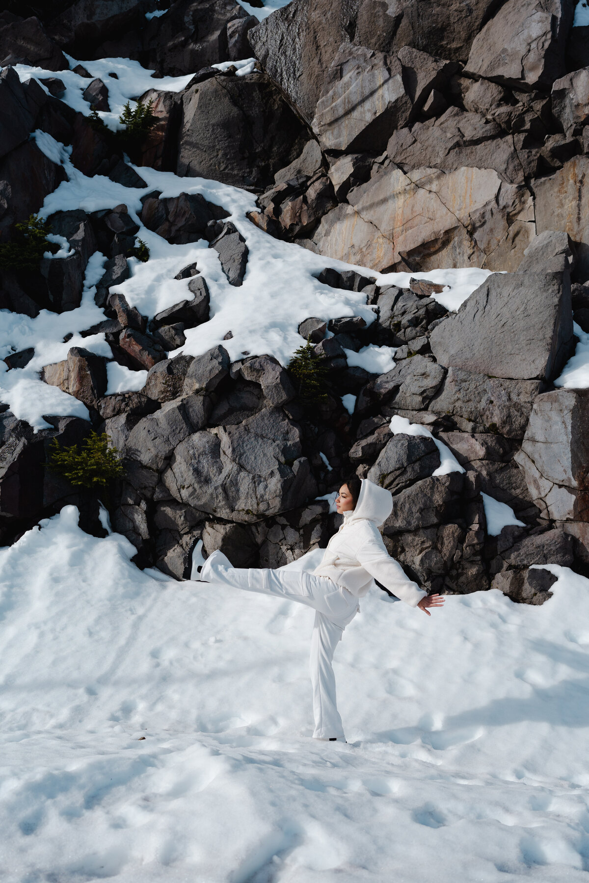 Woman in white dancing freely in snow-covered forest – winter dream portrait by Mewphotovideo