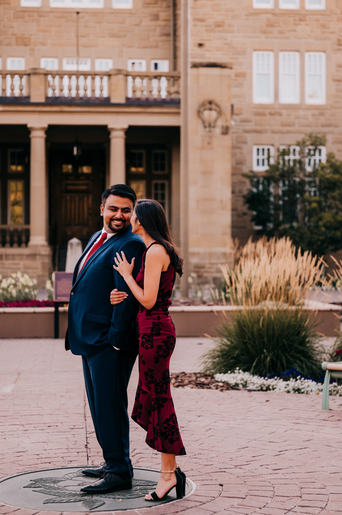 Couple in love looking at each other in the garden of a historical building