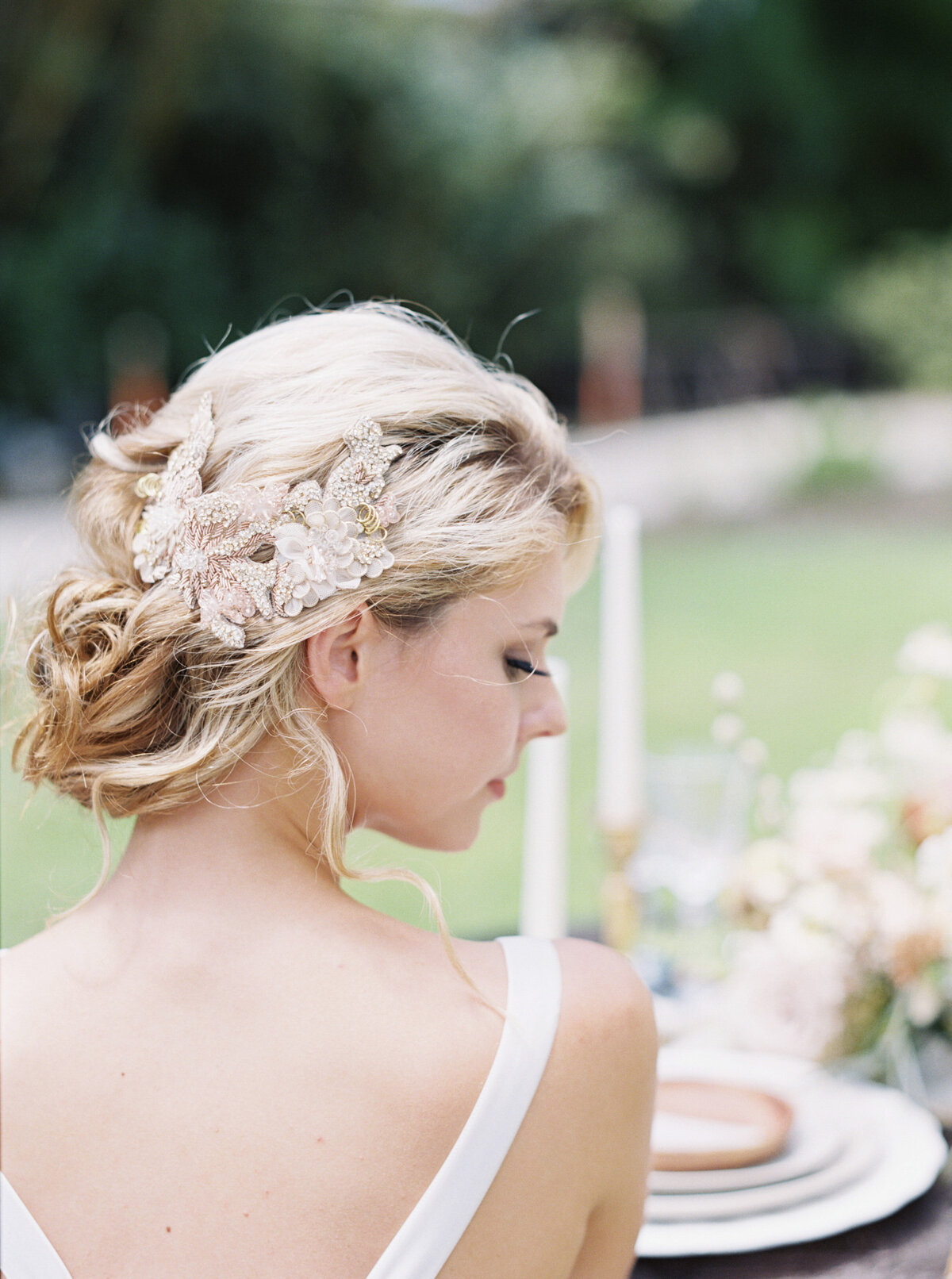 Flowers stand woven into a brides braids.