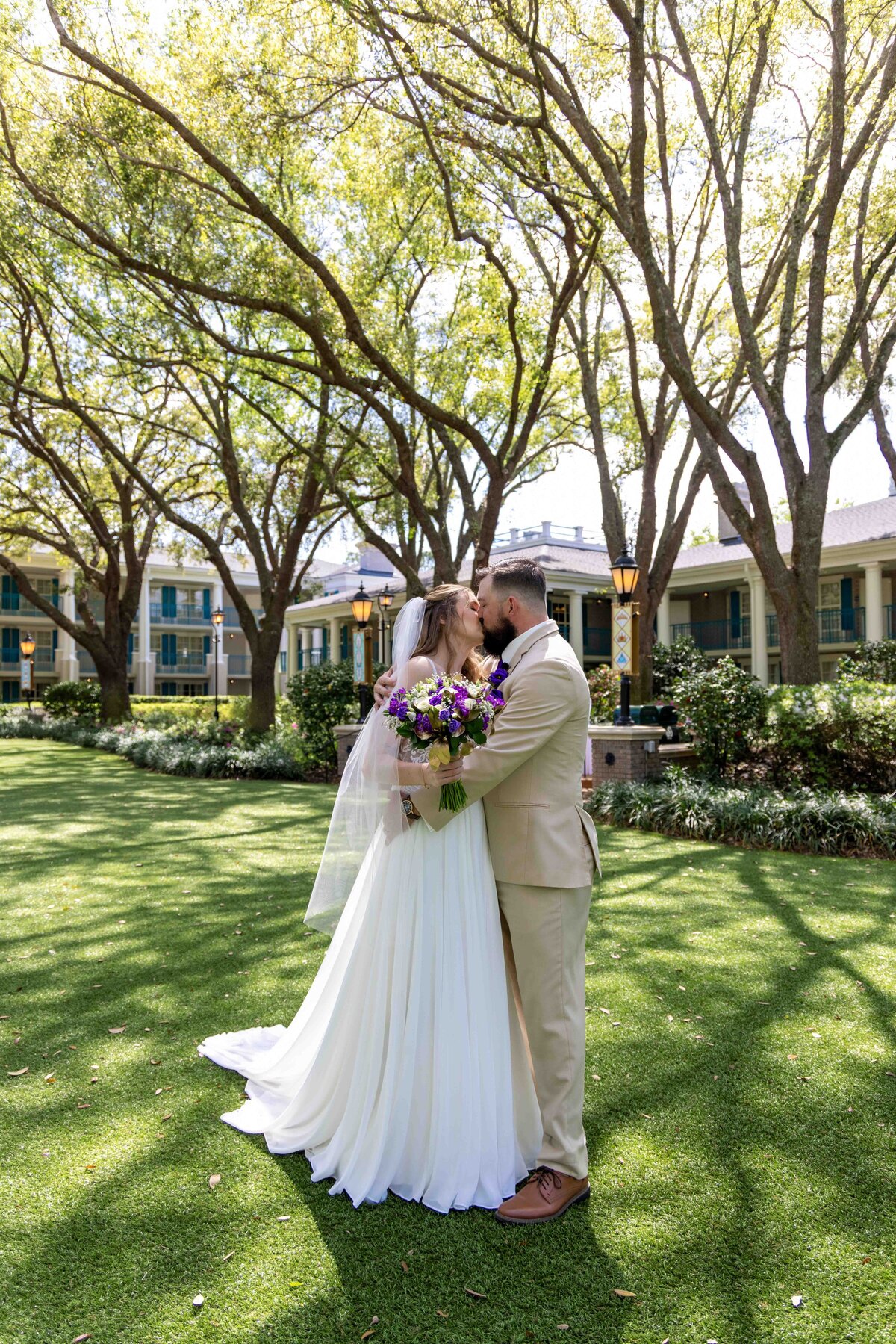 Bride and groom exchanging vows at outdoor Orlando wedding ceremony under oak trees
