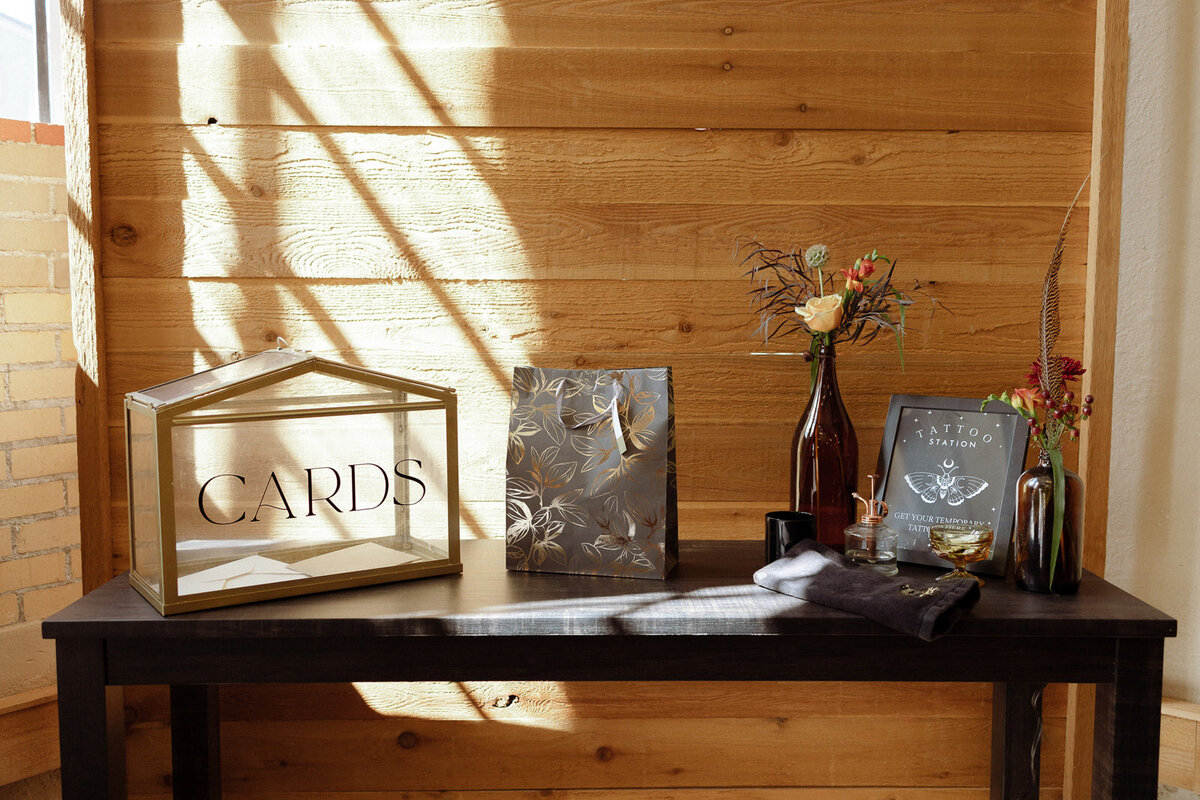Welcome table details with a card box and fall colored flower details.