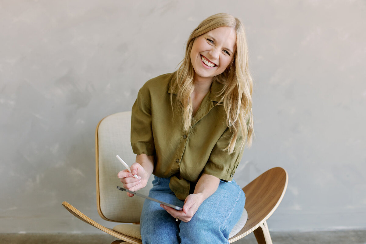 Fort Worth business coach working on laptop during branding session.