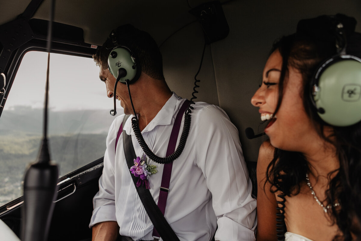 Wedding couple eloping in the Smoky Mountains and flying in helicopter with adventure elopement photographer.