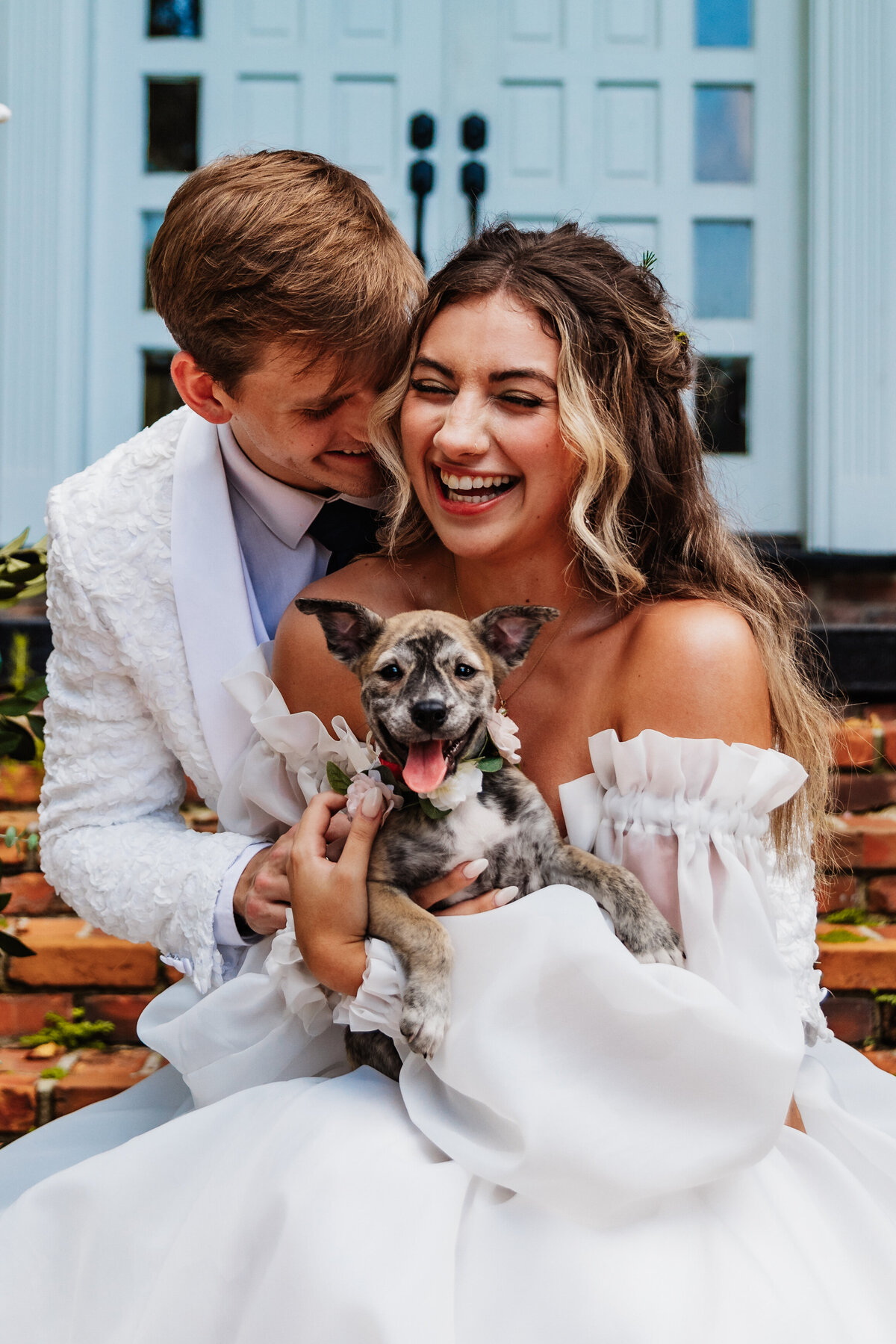 Shannon Lee, from Love Like Wild Photography, captures a joyful couple laughing together while holding their happy puppy.