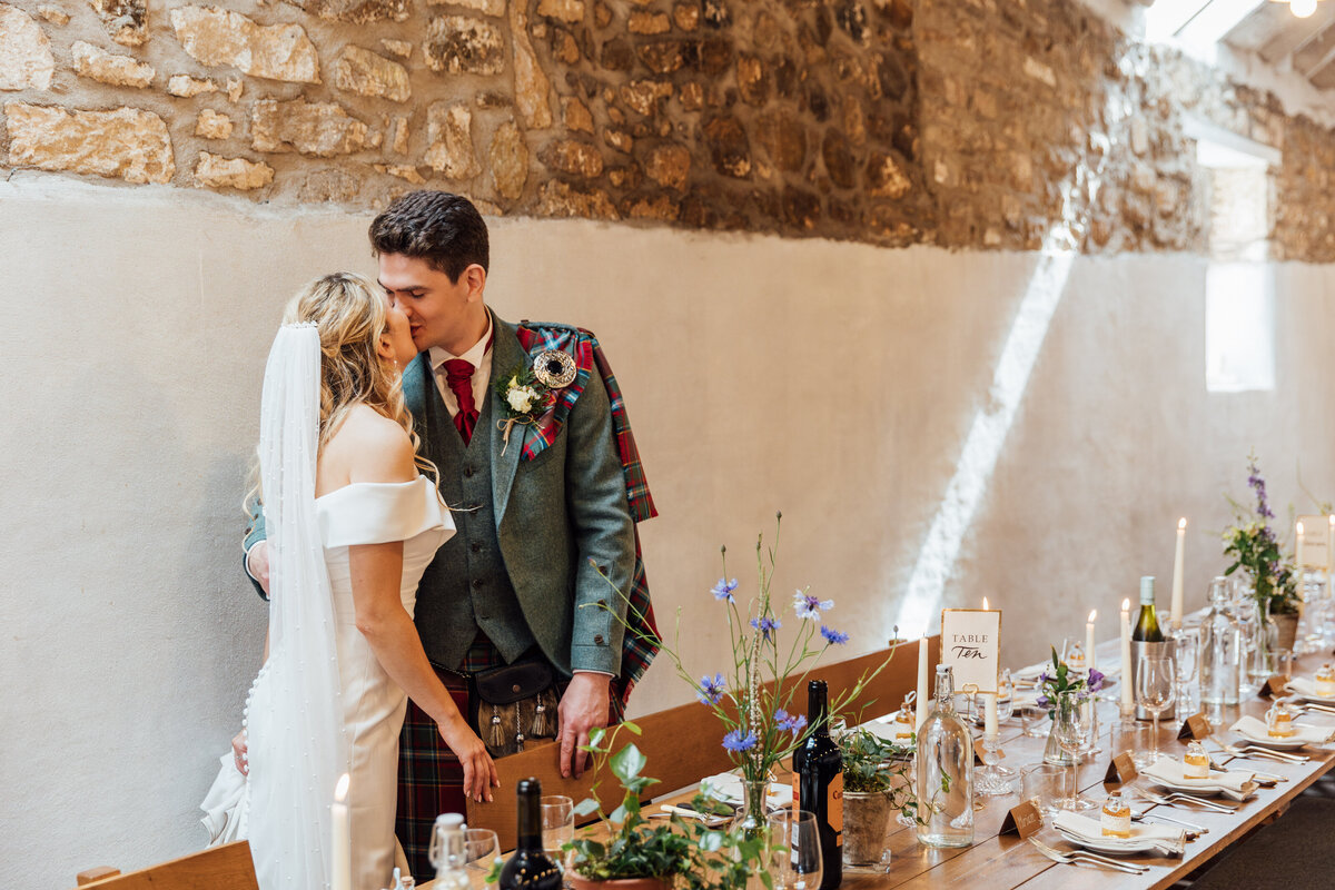 Bride and groom look at table decor at The Free Company