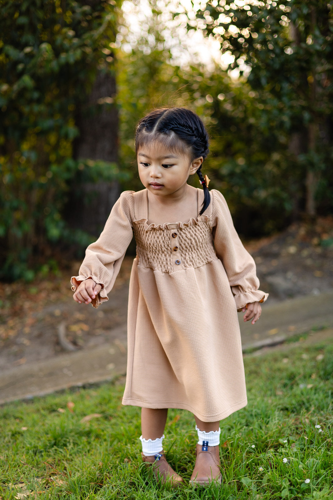Little girl in tan dress exploring the park during Bay Area school photography lifestyle session – Ellobelle Photography