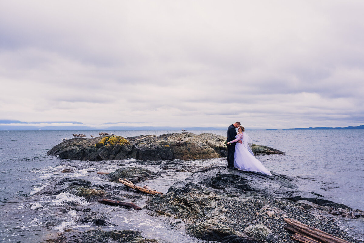 Couple on rocks in the ocean