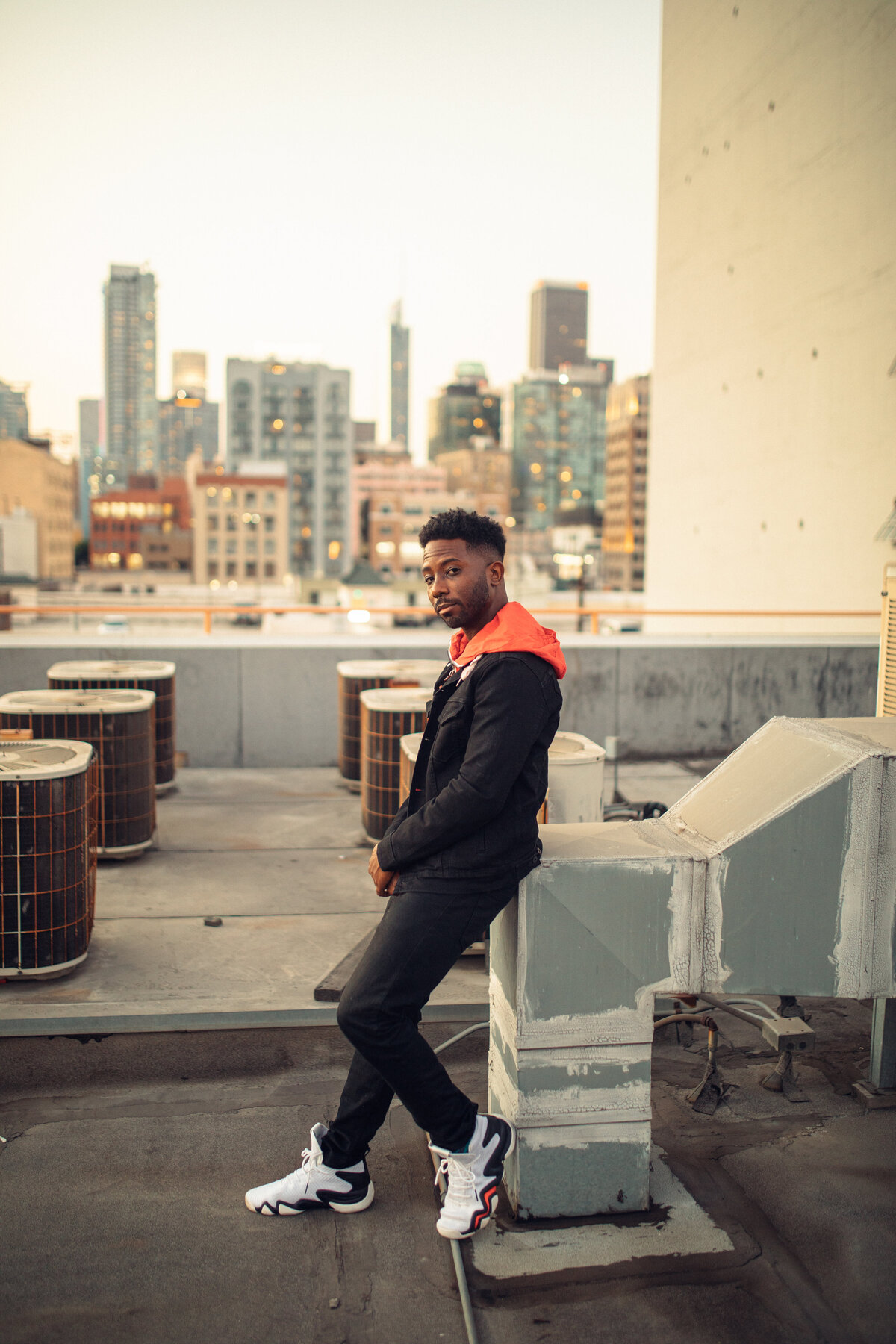 Portrait Photo Of Young Black Man In Black Coat And White Rubber Shoes Los Angeles