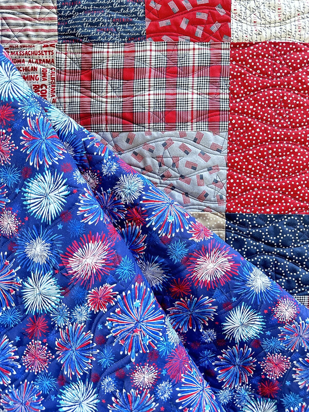 This red white and blue quilt features waves with star drop ins.