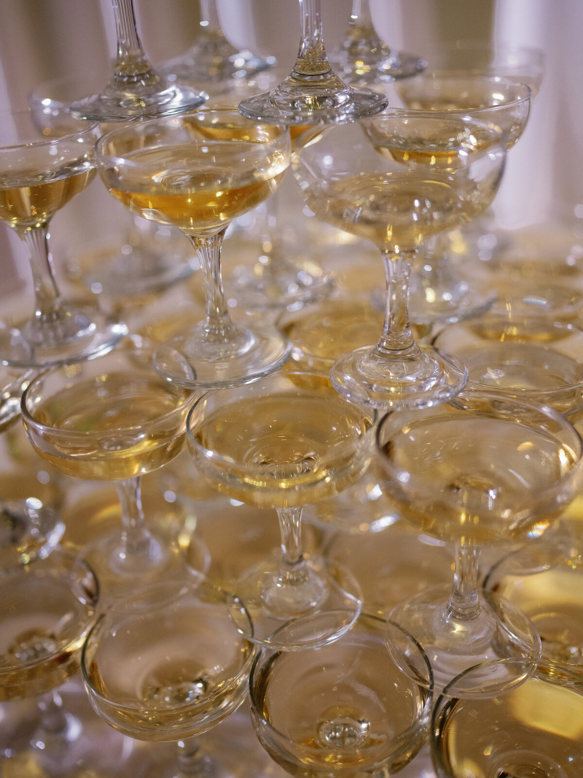 Champagne tower at wedding reception with cascading bubbly