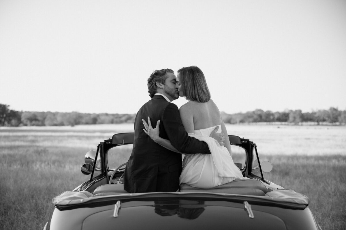 Married couple in getaway car after wedding