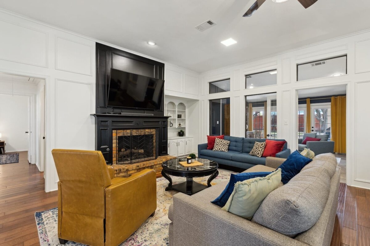 10216_shadow_way_dallas_tx_living_room_-_statement_fireplace_with_contrasting_trim_and_builtins_-_haven_realty_group