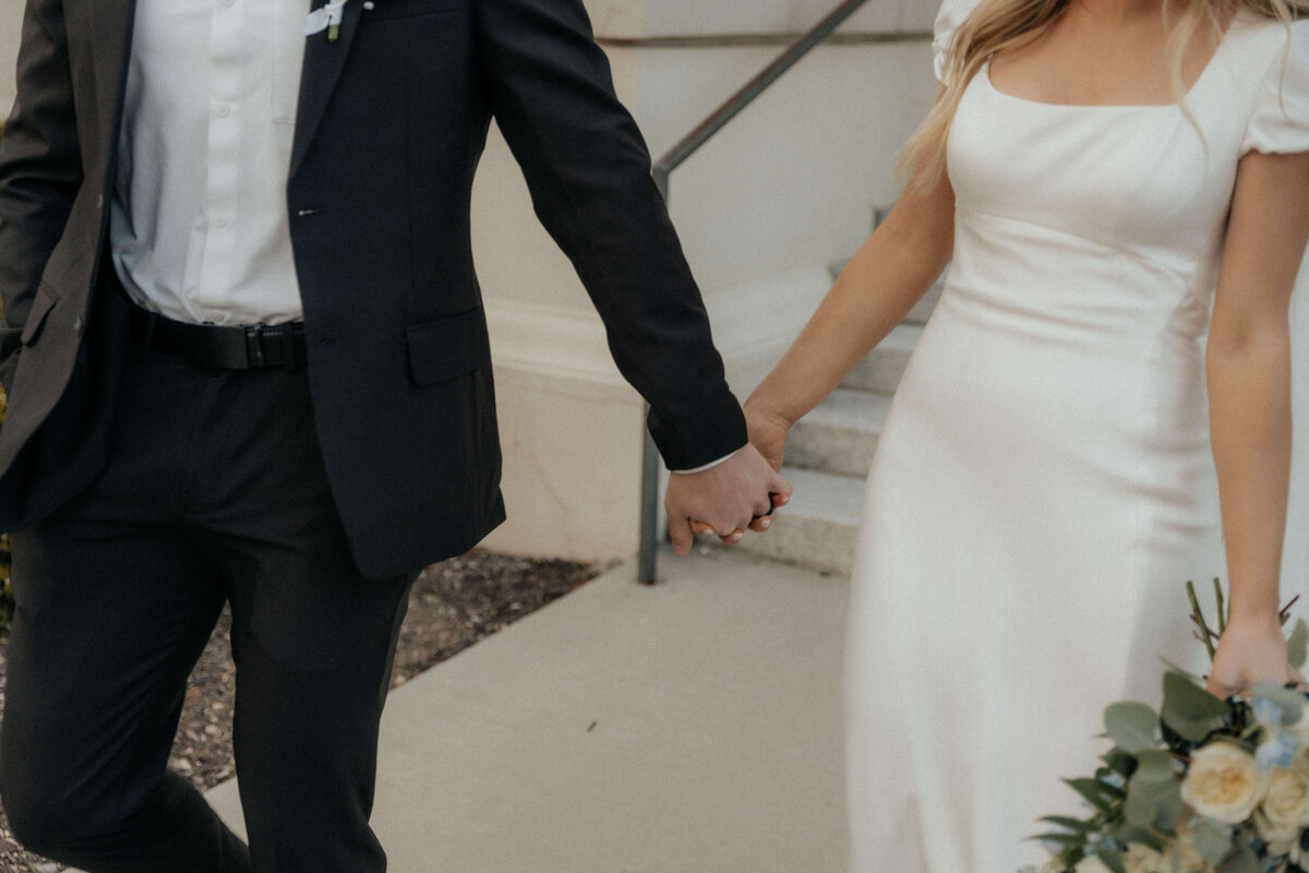 utah-wedding-couple-holding-hands-elegant-attire
